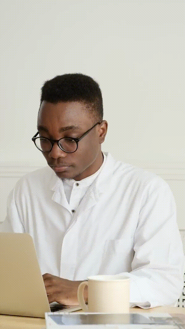 Doctor reviewing patient record on his laptop