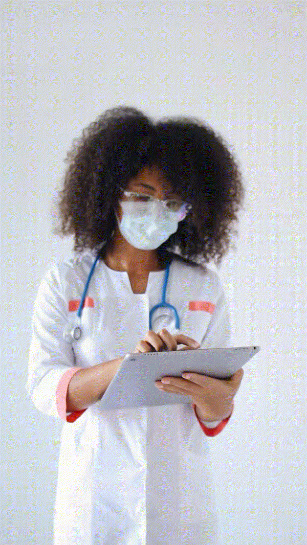 Nurse recording symptoms on her tablet